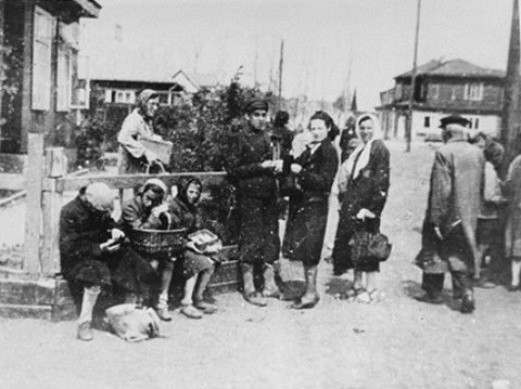 A group of Jewish women are gathered near the market square in the Kovno ghetto